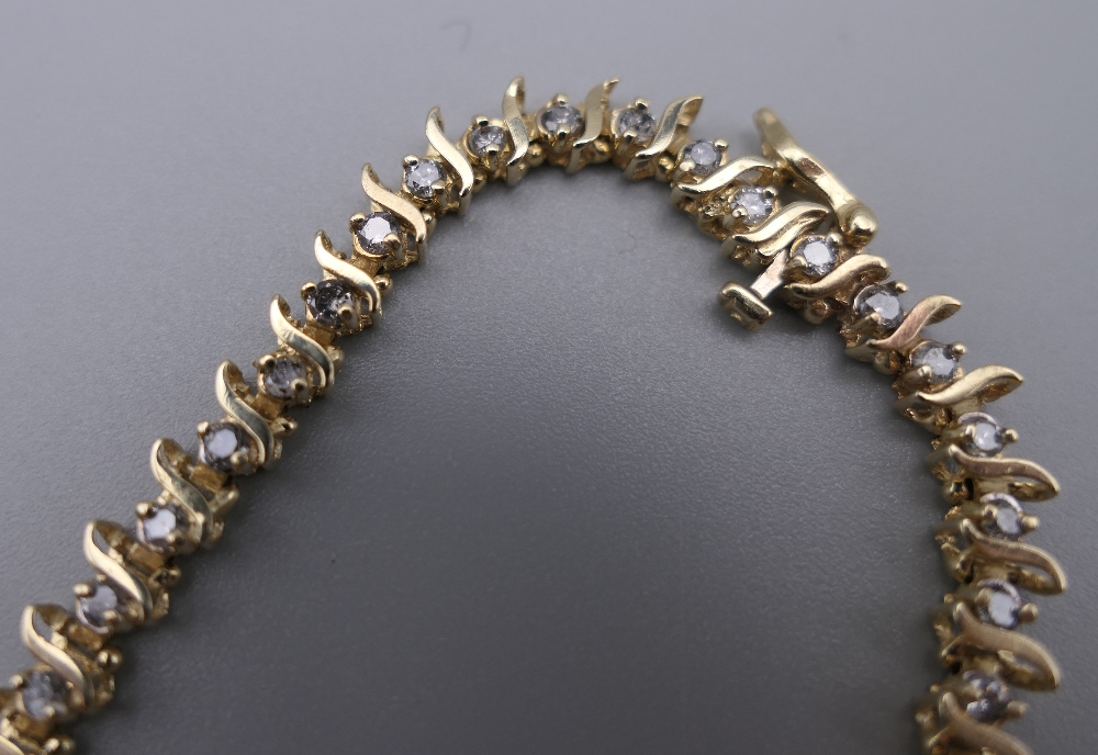 A 14 K gold diamond tennis bracelet with forty-seven diamonds, 0. - Image 3 of 9
