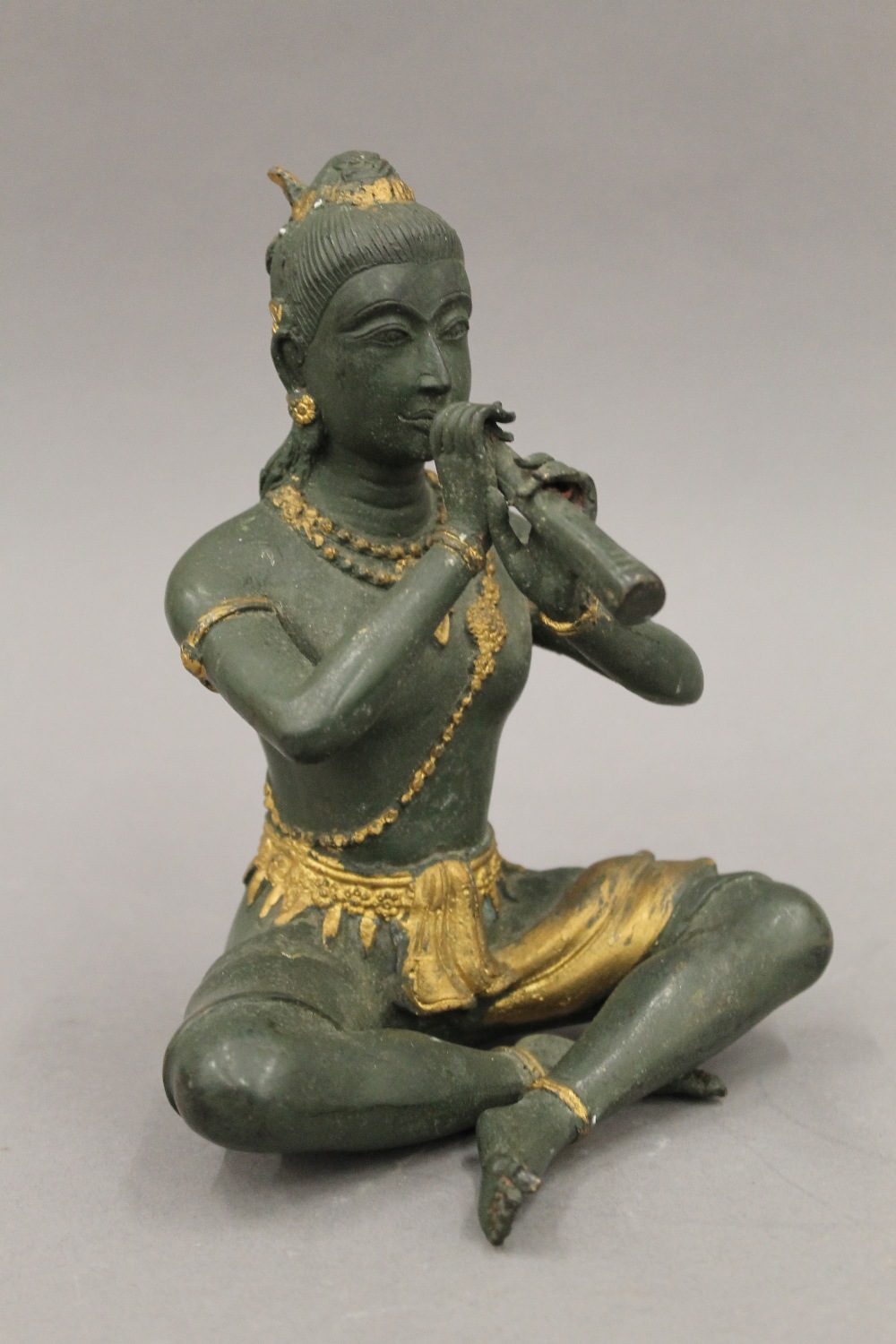 A bronze model of Buddha playing a flute. 18.5 cm high. - Image 2 of 5