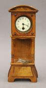 A Victorian walnut miniature longcase clock. 25.5 cm high.