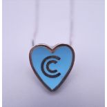 A silver enamel heart shaped pendant/brooch on chain.
