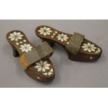 A pair of Eastern mother-of-pearl and unmarked white metal inlaid ladies shoes. 23 cm long.
