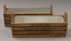 A pair of wooden boxes, inscribed 'Harrod's'. 34.5 cm long.