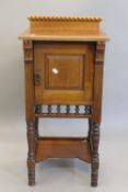 An Arts & Crafts walnut pot cupboard. 85.5 cm high.