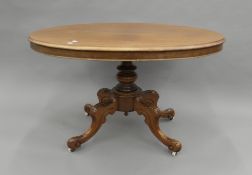 A Victorian walnut loo table. 124 cm long.