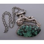 A large Oriental silver and turquoise pendant on a sterling silver chain. The pendant 7 cm wide.