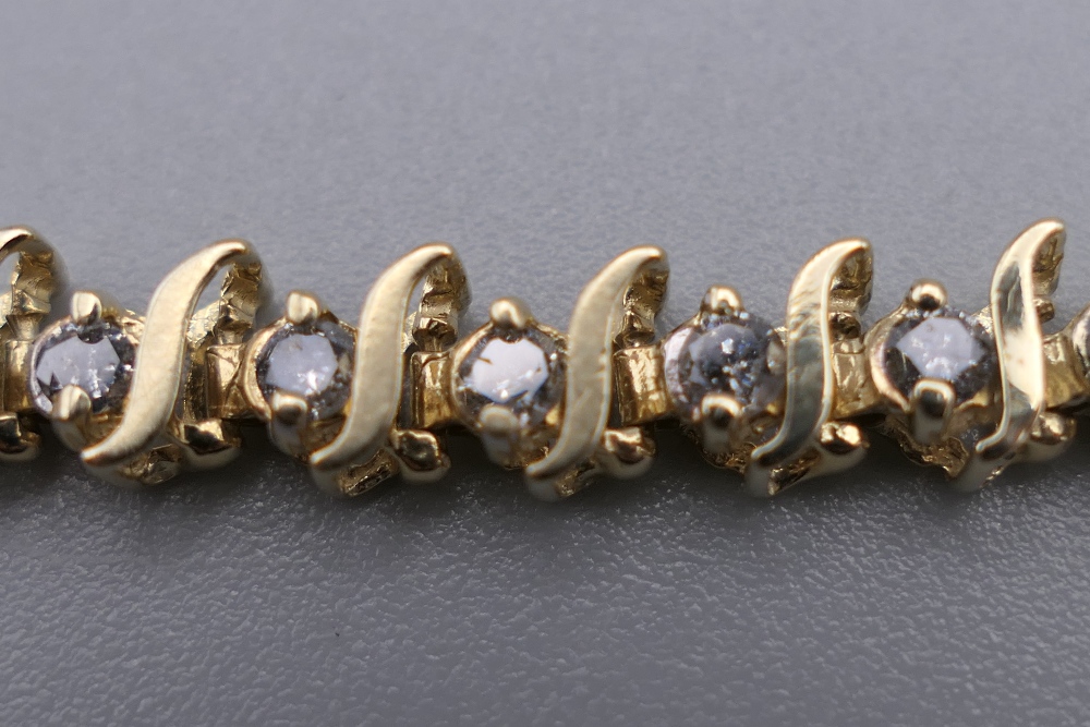 A 14 K gold diamond tennis bracelet with forty-seven diamonds, 0. - Image 6 of 9