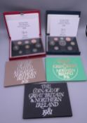 Five British proof coin sets.