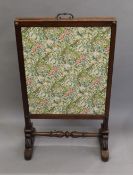 An early 19th century mahogany fire screen. 63.5 cm wide.