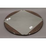 An Art Deco clear and peach glass mirror. 50 cm diameter.