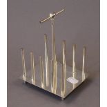 A silver plated Christopher Dresser style toast rack. 12.5 cm long.