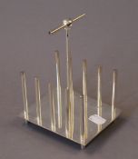 A silver plated Christopher Dresser style toast rack. 12.5 cm long.