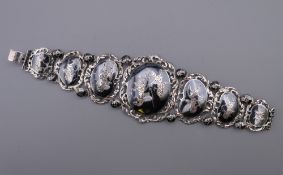 A Siam sterling silver and niello bracelet finely worked in seven hinged sections. 17.5 cm long.