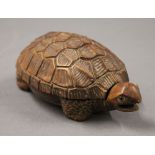 A Japanese carved wood tortoise form box. 11 cm long.