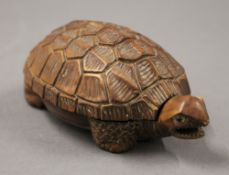 A Japanese carved wood tortoise form box. 11 cm long.