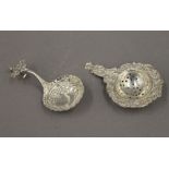 An 800 silver tea strainer and a Continental silver spoon. The former 11 cm long. 65.2 grammes.