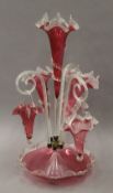 A Victorian cranberry glass epergne, with one branch lacking. 56.5 cm high.