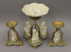 A Victorian Parian mounted centrepiece with a pair of matching candle lamps. The former 31.