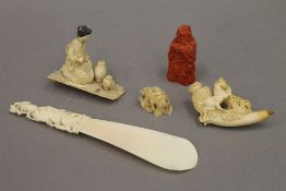 A 19th century Chinese ivory shoe horn, a 19th century Japanese carved ivory okimono,