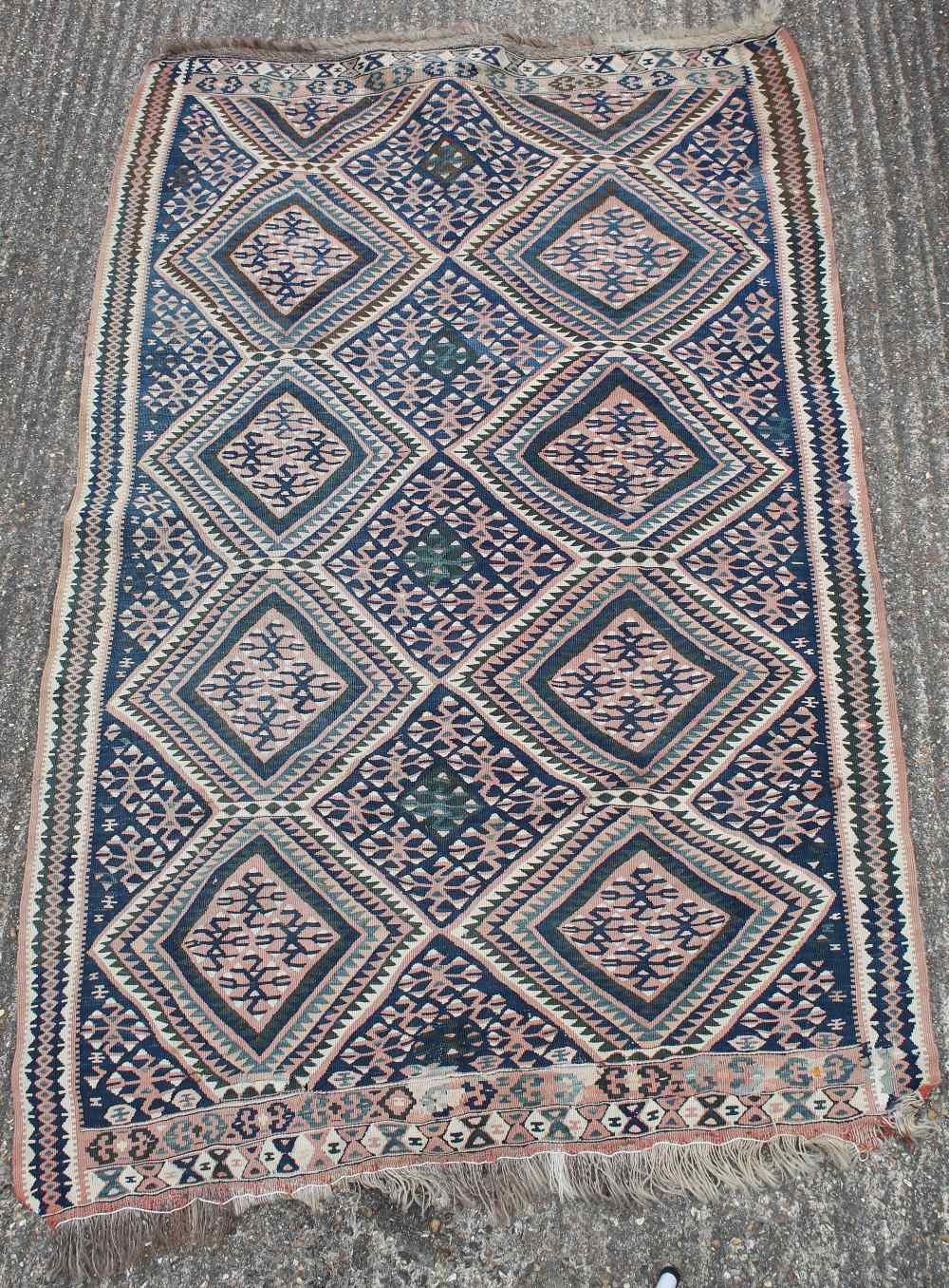 A Caucasian wool rug, 145 x 220 cm and a cream ground rug, 90 x 40 cm.