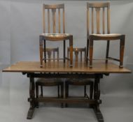 An oak refectory table and a set of four dining chairs. The table 167 cm long.