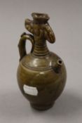 A Chinese green pottery vase/jug. 16 cm high.