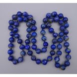 A string of lapis lazuli beads. 80 cm long.