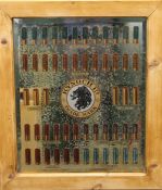 A pine framed mirror decorated with cartridges. 65 x 75 cm.