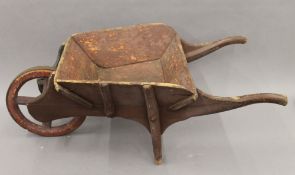 A 19th century child's wheelbarrow. 71 cm long.