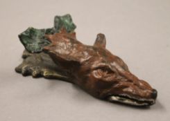 A painted bronze fox mask letter clip. 15 cm long.