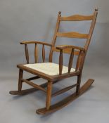 An early 20th century oak rocking chair. 67 cm wide.