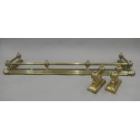 A Victorian brass fender and matching fire dogs. The former 155 cm wide.