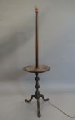 A mahogany standard lamp. 144 cm high.