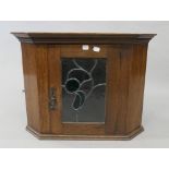 An early 20th century lead glazed oak hanging corner cupboard. 46 cm high.