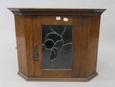 An early 20th century lead glazed oak hanging corner cupboard. 46 cm high.