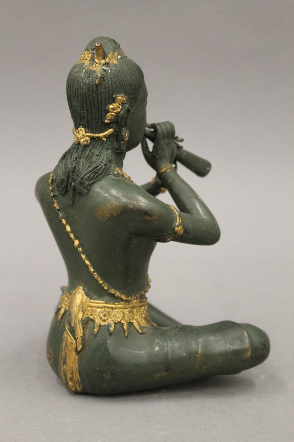 A bronze model of Buddha playing a flute. 18.5 cm high. - Image 3 of 5