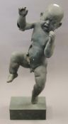 A patinated bronze model of a baby. 60 cm high.