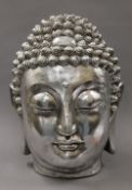 A silvered model Buddha head. 42 cm high.