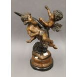 A patinated bronze model of cherubs. 48 cm high.