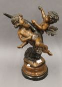 A patinated bronze model of cherubs. 48 cm high.