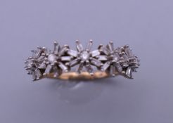 A 9 ct gold and diamond florally set ring. Ring size N/O.