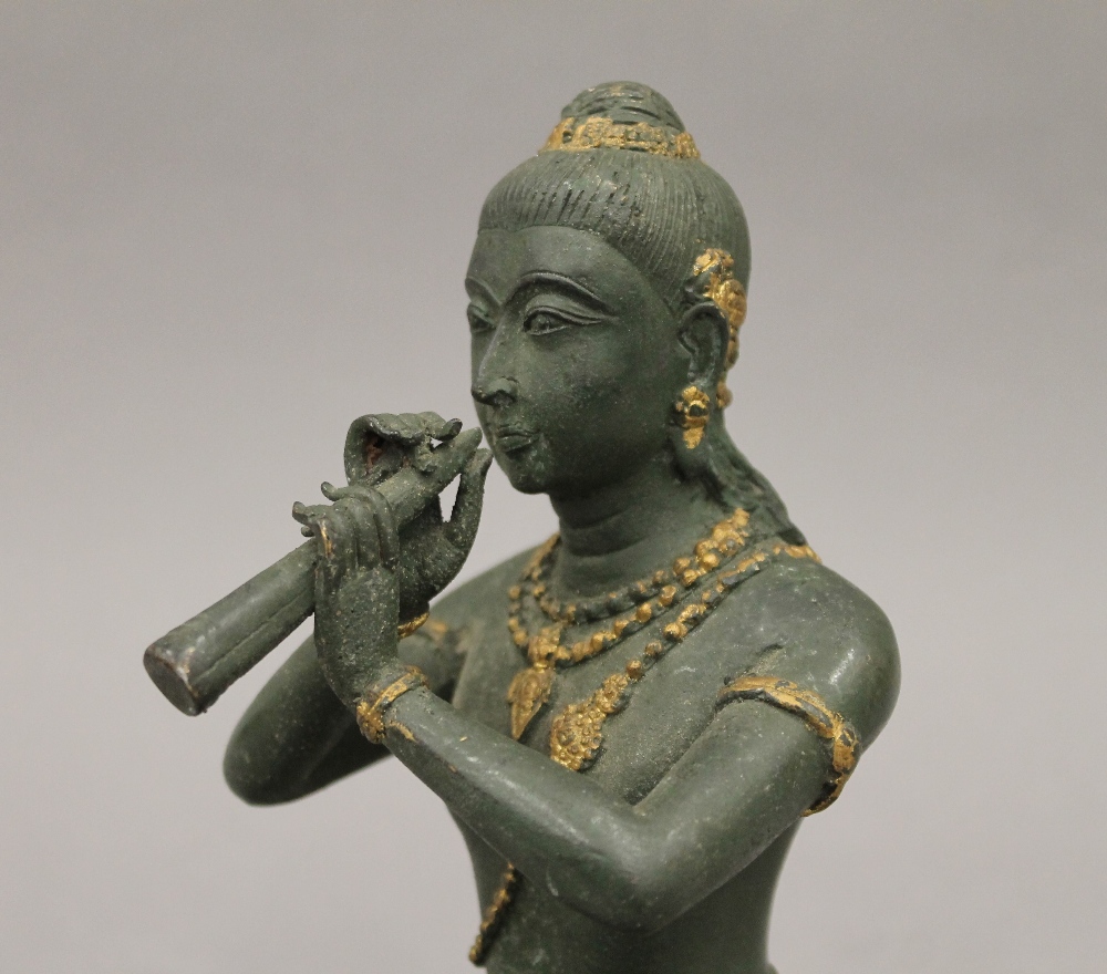 A bronze model of Buddha playing a flute. 18.5 cm high. - Image 5 of 5