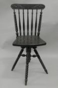 A Victorian ebonised carved revolving chair.