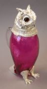 A cranberry and silver plated owl claret jug. 28 cm high.