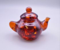 A small model of a teapot. 5 cm high.