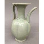 An Oriental celadon glazed jug. 21.5 cm high.