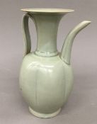 An Oriental celadon glazed jug. 21.5 cm high.