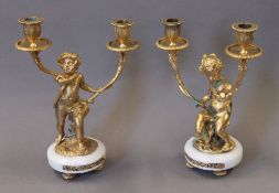 A pair of bronze cherub candelabra. 29.5 cm high.