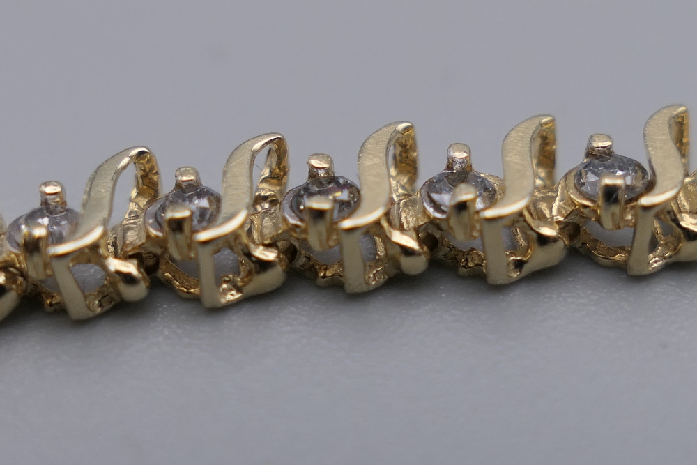A 14 K gold diamond tennis bracelet with forty-seven diamonds, 0. - Image 5 of 9