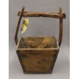 A Chinese wooden well bucket. 37.5 cm wide.