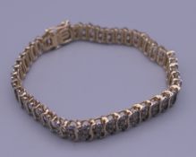 A 9 ct gold diamond set bracelet. 17.5 cm long.